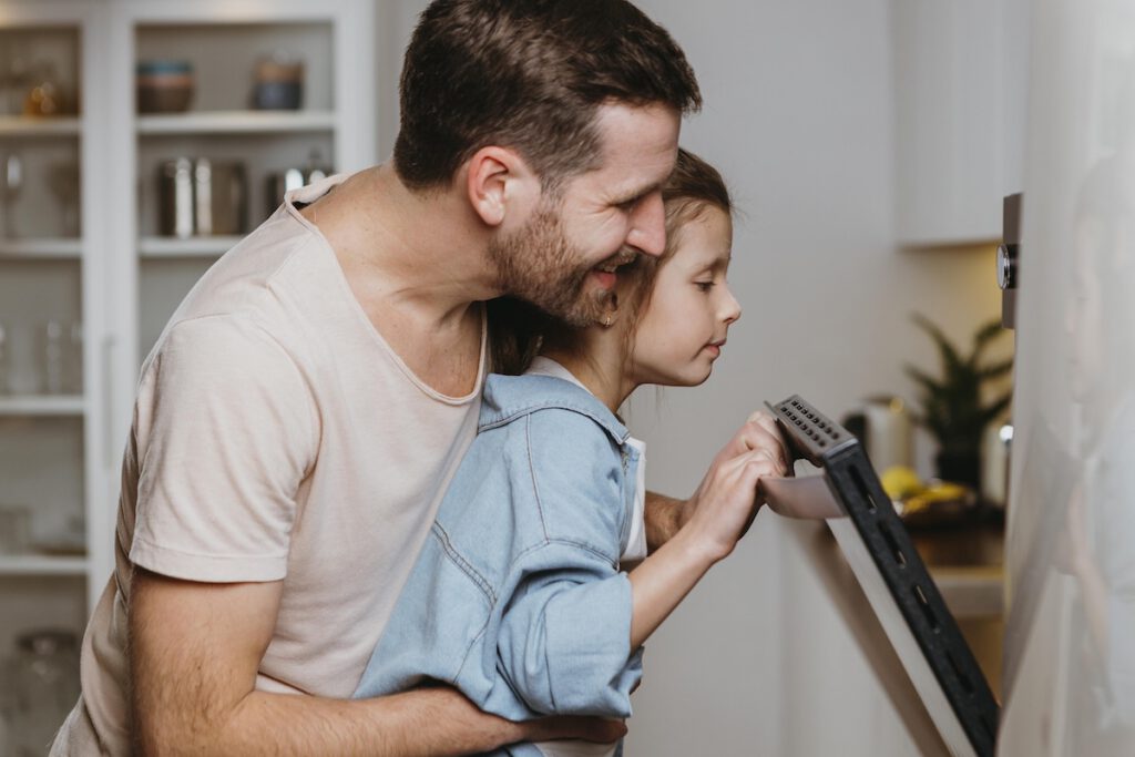 Dad and Daughter baking in kitchen.