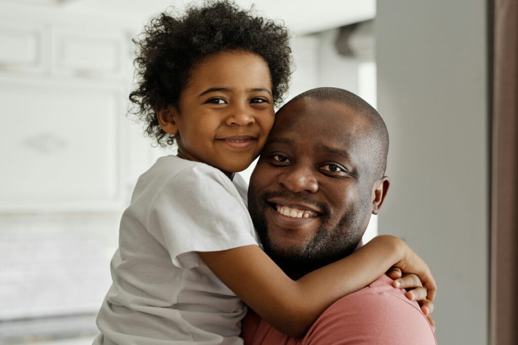 Dad and daughter hugging.